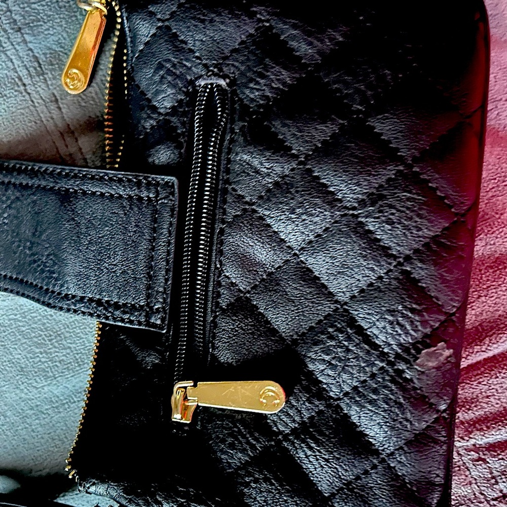 Small black purse 8x5 with gold trim and zippers